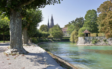 Tree lined River in Konstanz  Germany with church in the background
