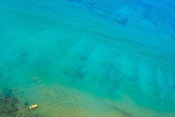 Aerial view of woman swimming alone in the ocean