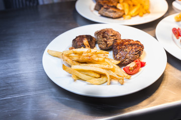 Lamp chop with french fries and tomatoes