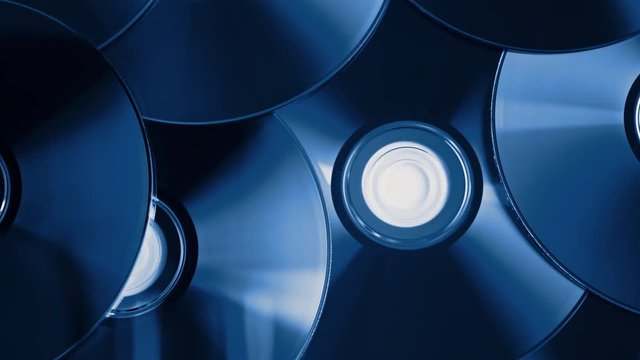 parallax tracking shot over a pile of digital versatile discs