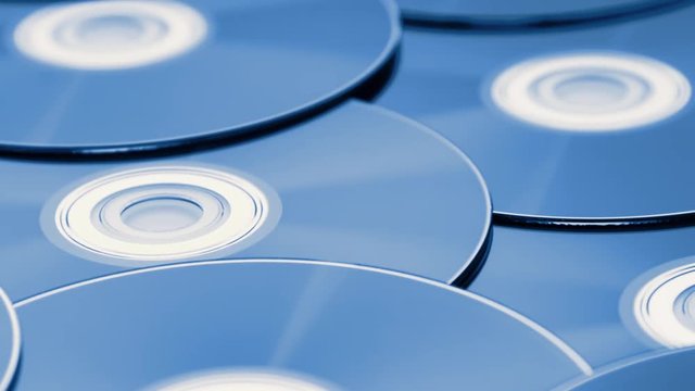 dolly tracking shot over a pile of digital versatile discs
