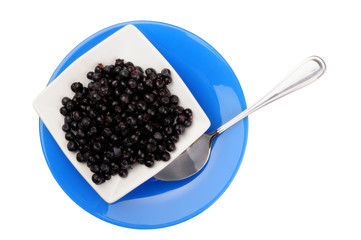 blackberry on white plate over blue plate. view above