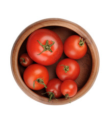 Autumn Still Life. Red juicy ripe tomato fruits lie in a wooden bowl. on a white background.