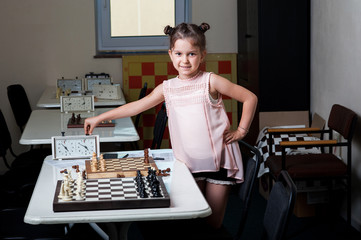 little girl playing chess