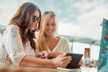Two young women having coffee break