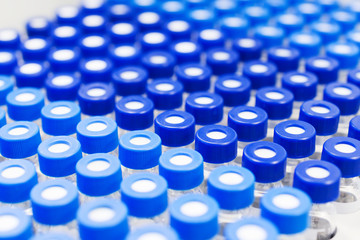 Rows of glass vials in the tray automatic liquid dispenser.