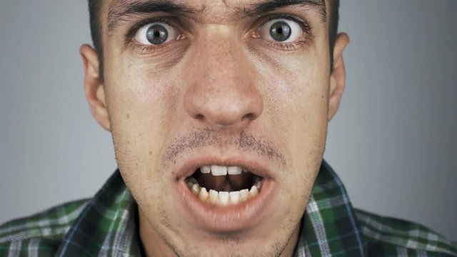 close-up of an aggressive man screaming