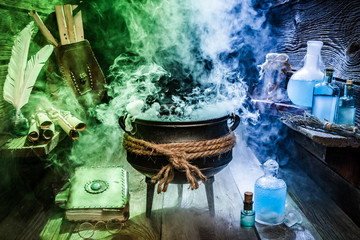 Old witcher cauldron with blue and green smoke for Halloween