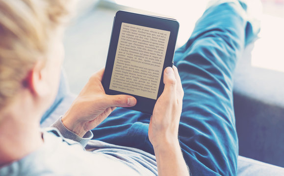Man reading a book on digital device