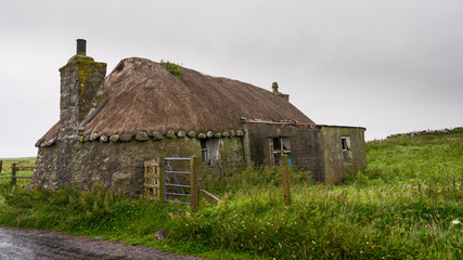 Fototapeta na wymiar Blackhouse with thatched roof of the 19th century in Scotland.