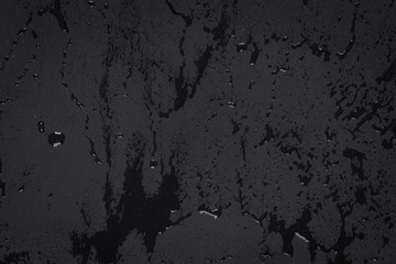 Water drops on dark stone surface