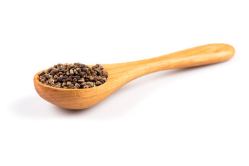 Decorticated cardamom seeds in a wooden spoon