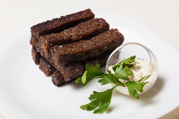 Toasts from black bread and sauce