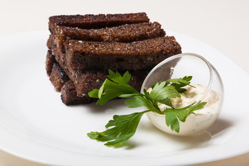 Toasts from black bread and sauce