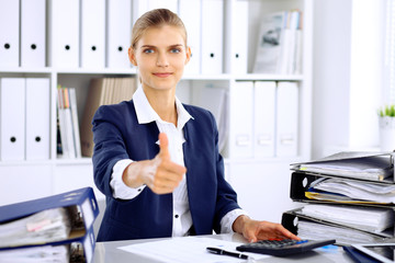 Modern business woman or confident female accountant, thumb up