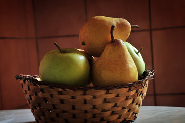 Basket of fruit, apples and pears, at kitchen table