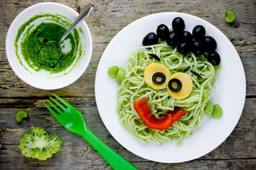 Pasta with green vegetables pesto shaped Frankenstein