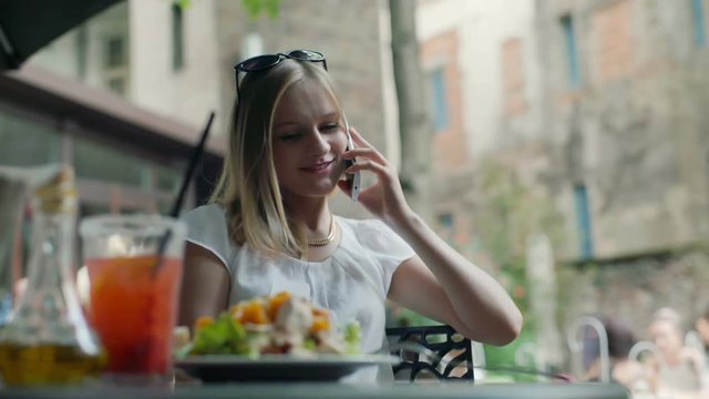 Happy, stylish businesswoman chatting on cellphone druing her break
