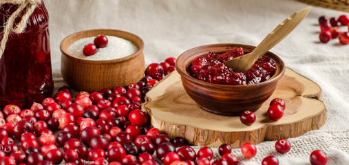 Cranberry and jam cranberry on a light background.