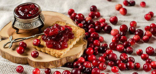 Breakfast with cranberries, jam and biscuits.