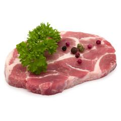 Raw pork neck chop meat with parsley herb leaves and peppercorn