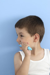 profile of a boy brushing his teeth with a toothbrush