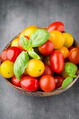 Tomatoes on the gray background. Colorful tomatoes, red tomatoes