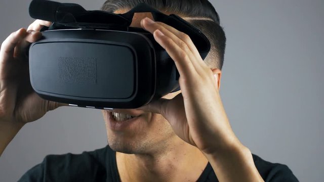 Close-up shot of man getting experience in using VR-headset.