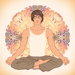 Beautiful Caucasian Man sitting in Lotus pose with ornate mandal
