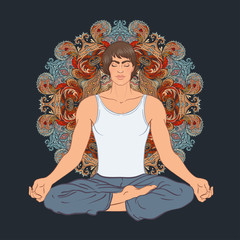 Beautiful Caucasian Man sitting in Lotus pose with ornate mandal