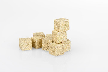 sugar cubes covered with gold on a white background