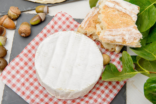 Camembert cheese on a red and white tablecloth