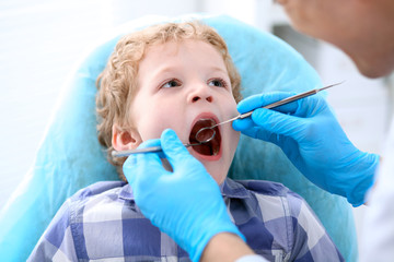 Close up of boy having his teeth examined by a dentist