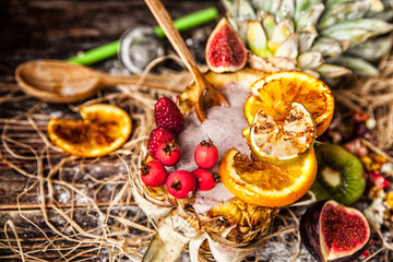Berry smoothie with berries in pineapple on rustic background