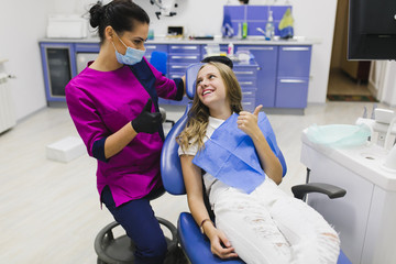 Dentist and patient handshake for friendship and respect