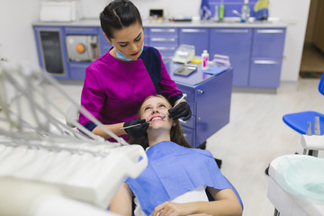 Dentist curing a female patient 