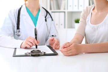 Doctor and patient are discussing something, just hands at the table