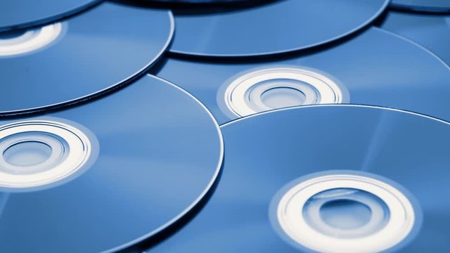 dolly tracking shot over a pile of digital versatile discs