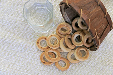 bagels in a basket with empty dishes on the table