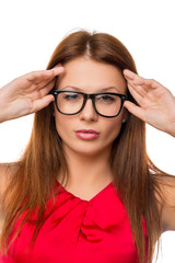 Fototapeta premium beautiful girl in glasses, straightens hair on a white backgroun