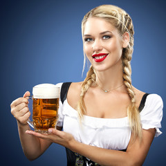Young sexy Oktoberfest waitress, wearing a traditional Bavarian dress, serving big beer mugs on blue background.