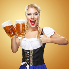 Young sexy Oktoberfest waitress, wearing a traditional Bavarian dress, serving big beer mugs on blue background. Thumbsup