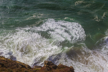 Fototapeta na wymiar Top view of isolated emerald ocean waves with white foam, Praia