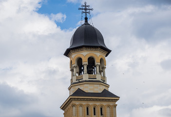 Fototapeta na wymiar Bell tower of Coronation Cathedral deticated to Holy Trinity in Citadel of Alba Iulia city in Romania
