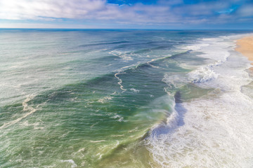 Fototapeta na wymiar Top view of Praia do Norte beach in Nazare, Portugal