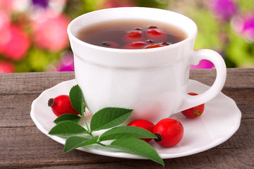 Tea from the hips on the wooden table with a blurred background