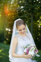 Fototapeta na wymiar Beautiful bridal bouquet in hands of young bride dressed in white wedding dress.