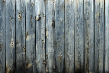 Background from old boards with knots and scratches. traces of the influence of weather. partially tinted photo.