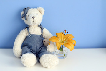 teddy bear with a glass with a lily