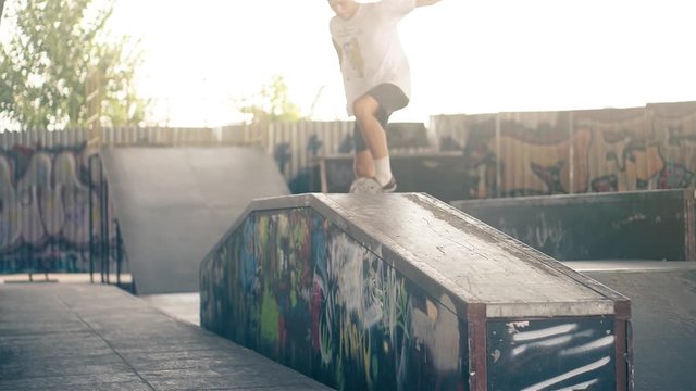Skateboarder on skate doing jump tricks HD slow motion video on skateboard park. Urban extreme sport lifestyle